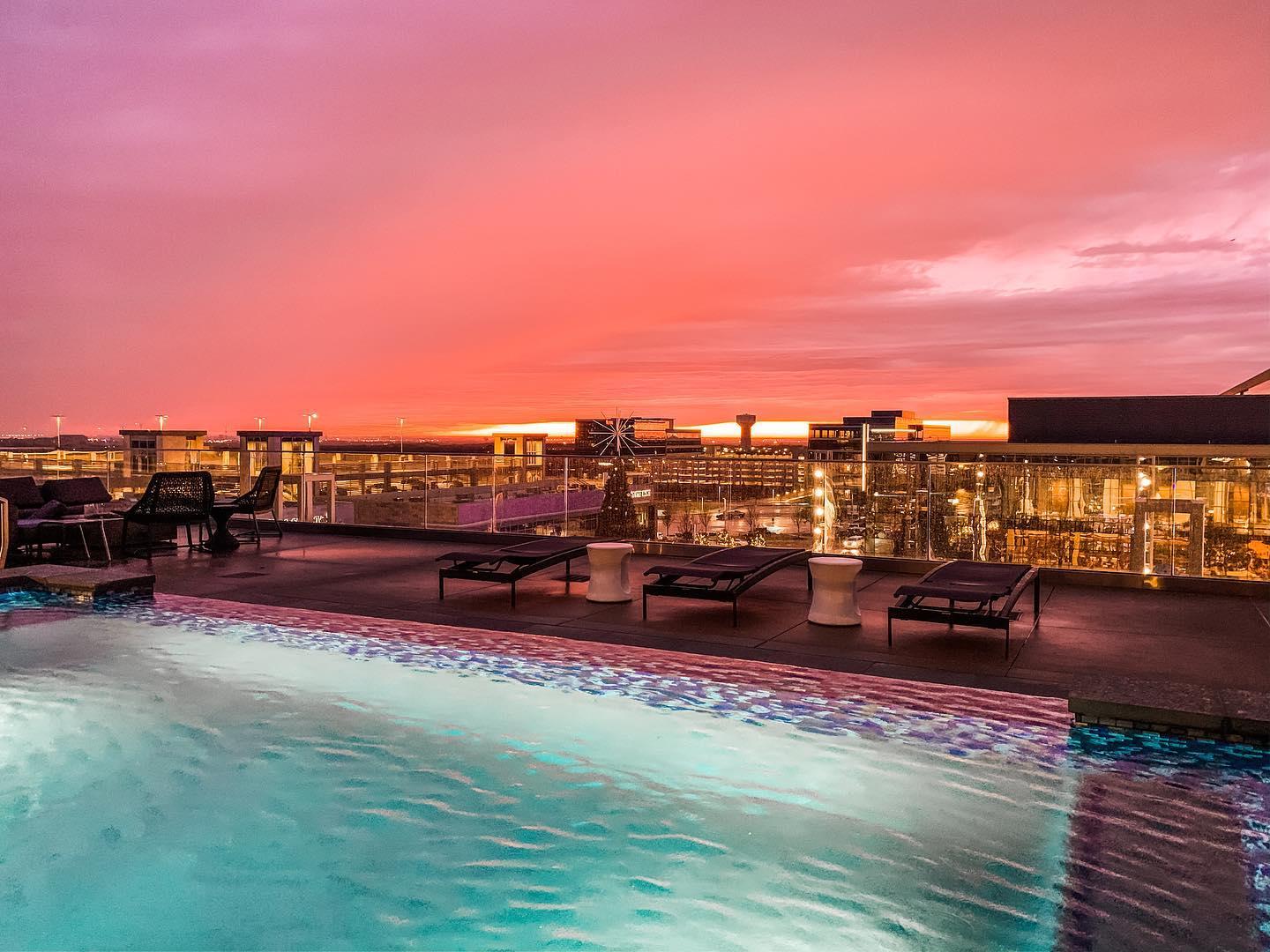 A rooftop pool at sunset