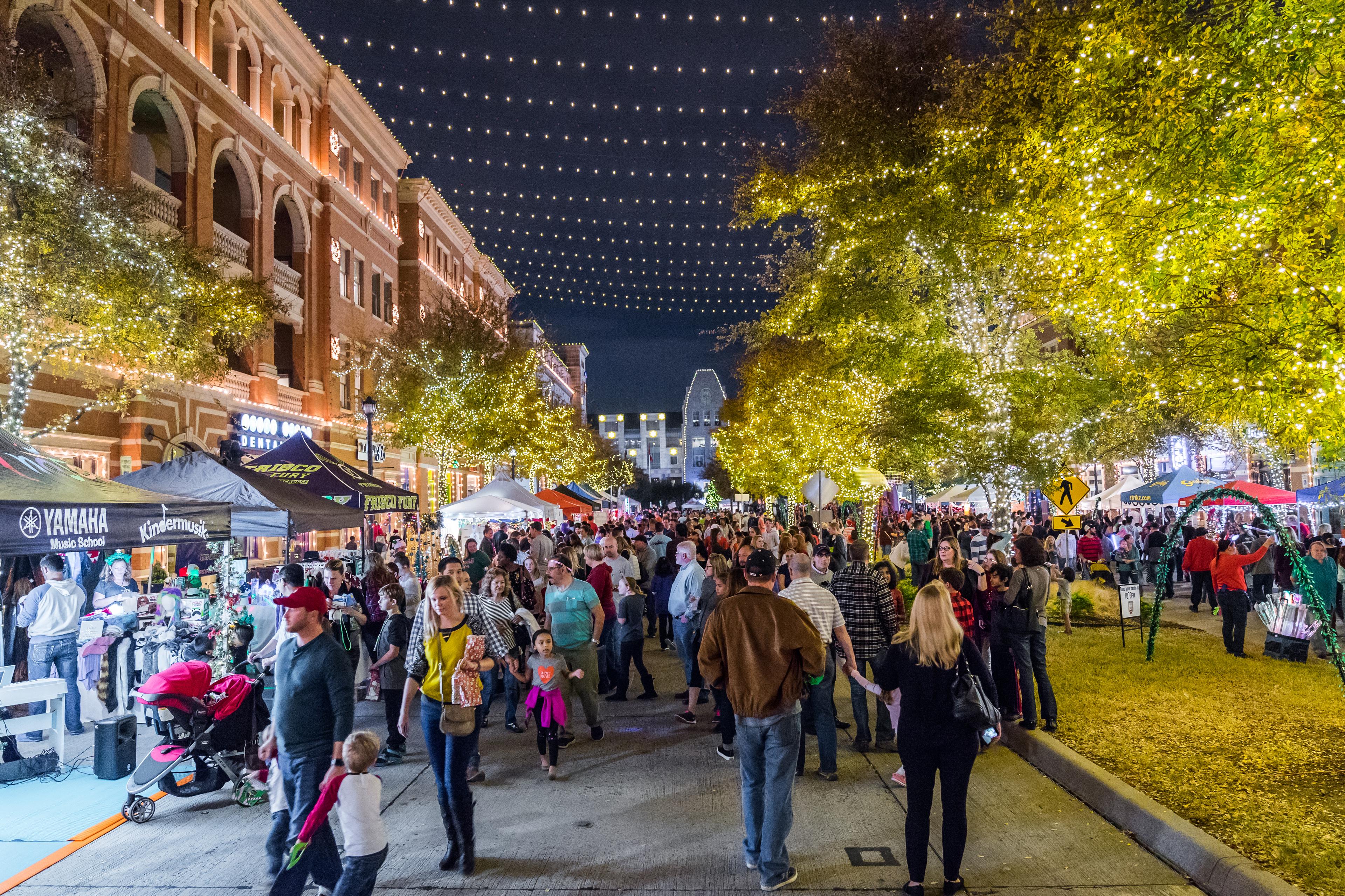 people gathering in the square for a Christmas market