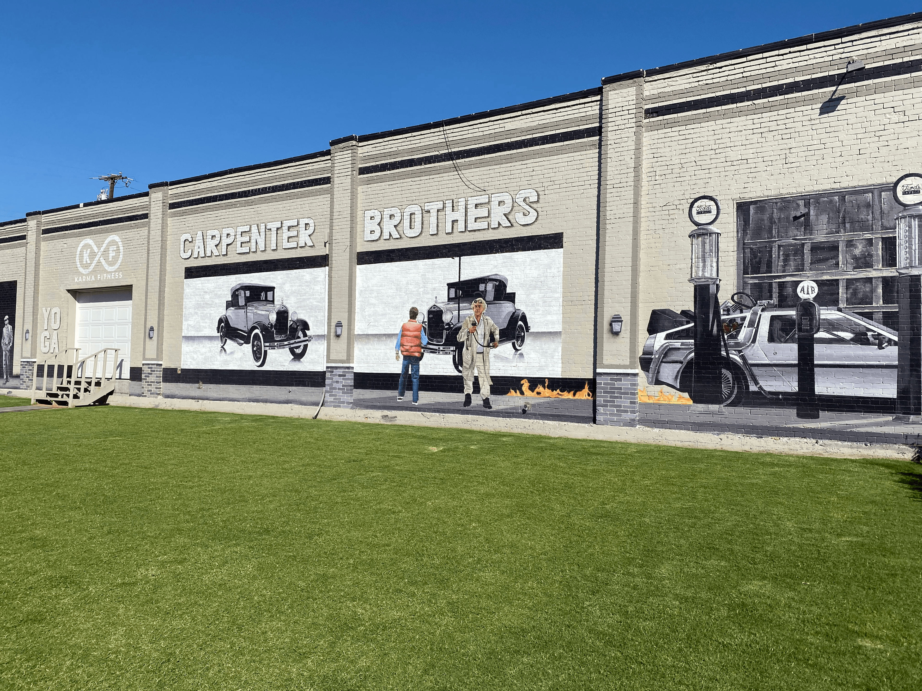 Mural of Marty McFly, Doc, and the Delorean looking at old cards