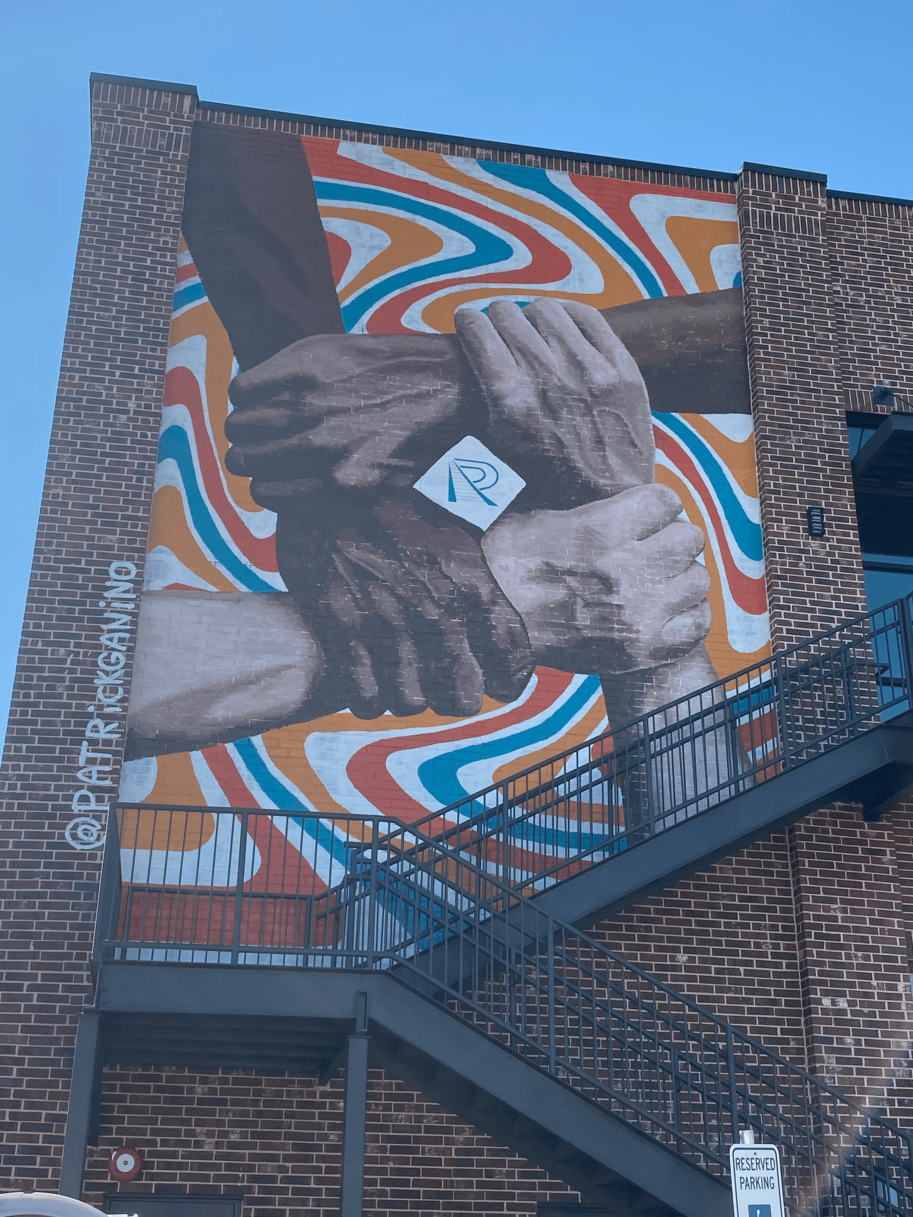 Mural of four people holding each others wrists