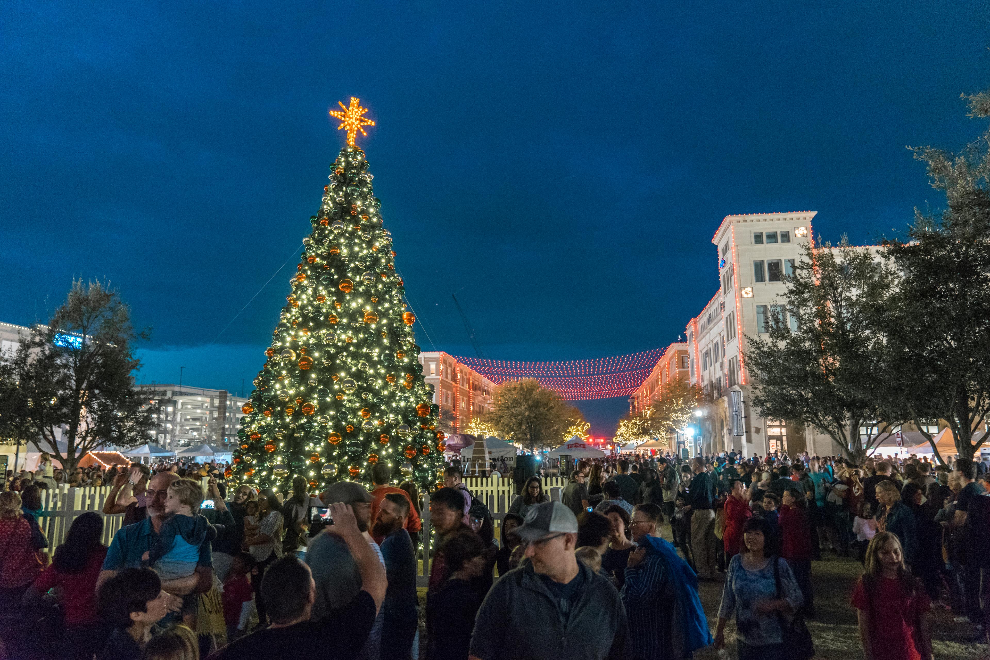 people gathering in the square for a Christmas market