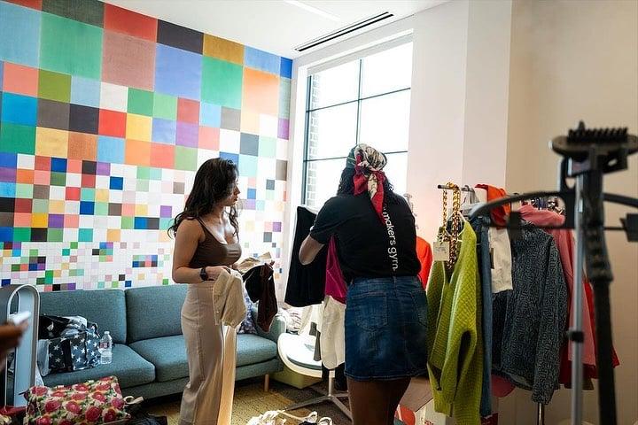 a women helping another women with choosing clothes