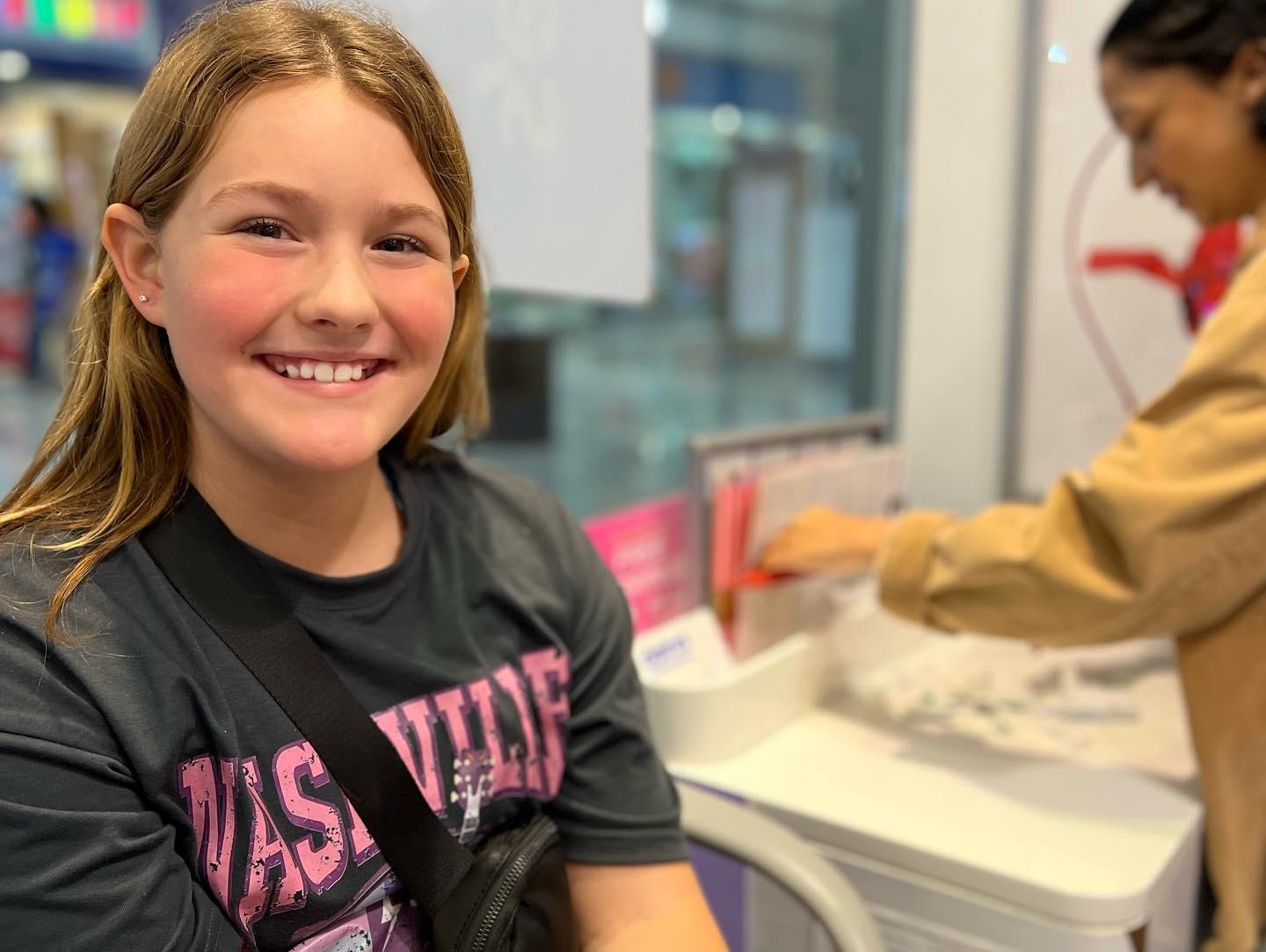 A young girl smiles for a photo.