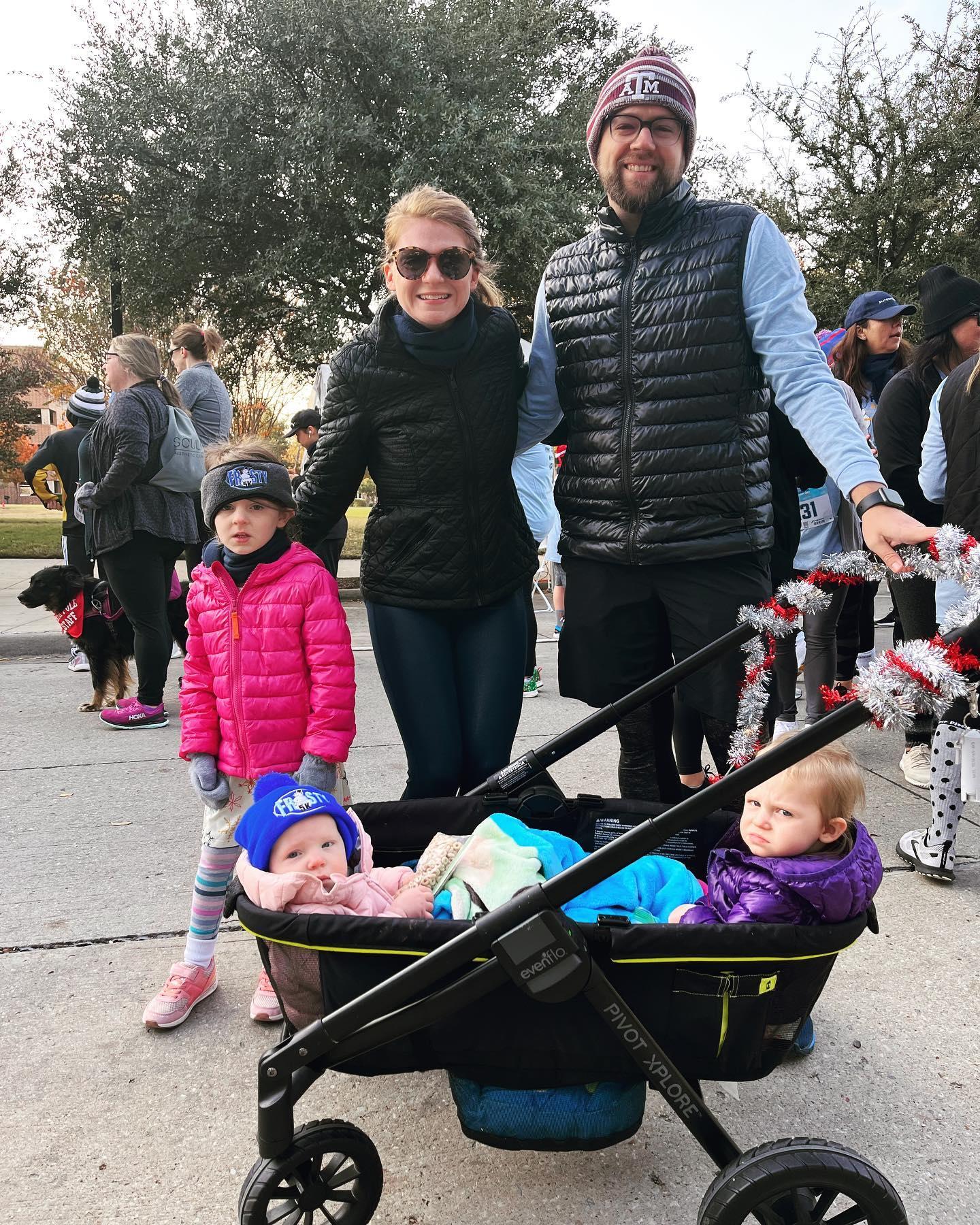 A family poses for a photo wearing winter weather outfits.