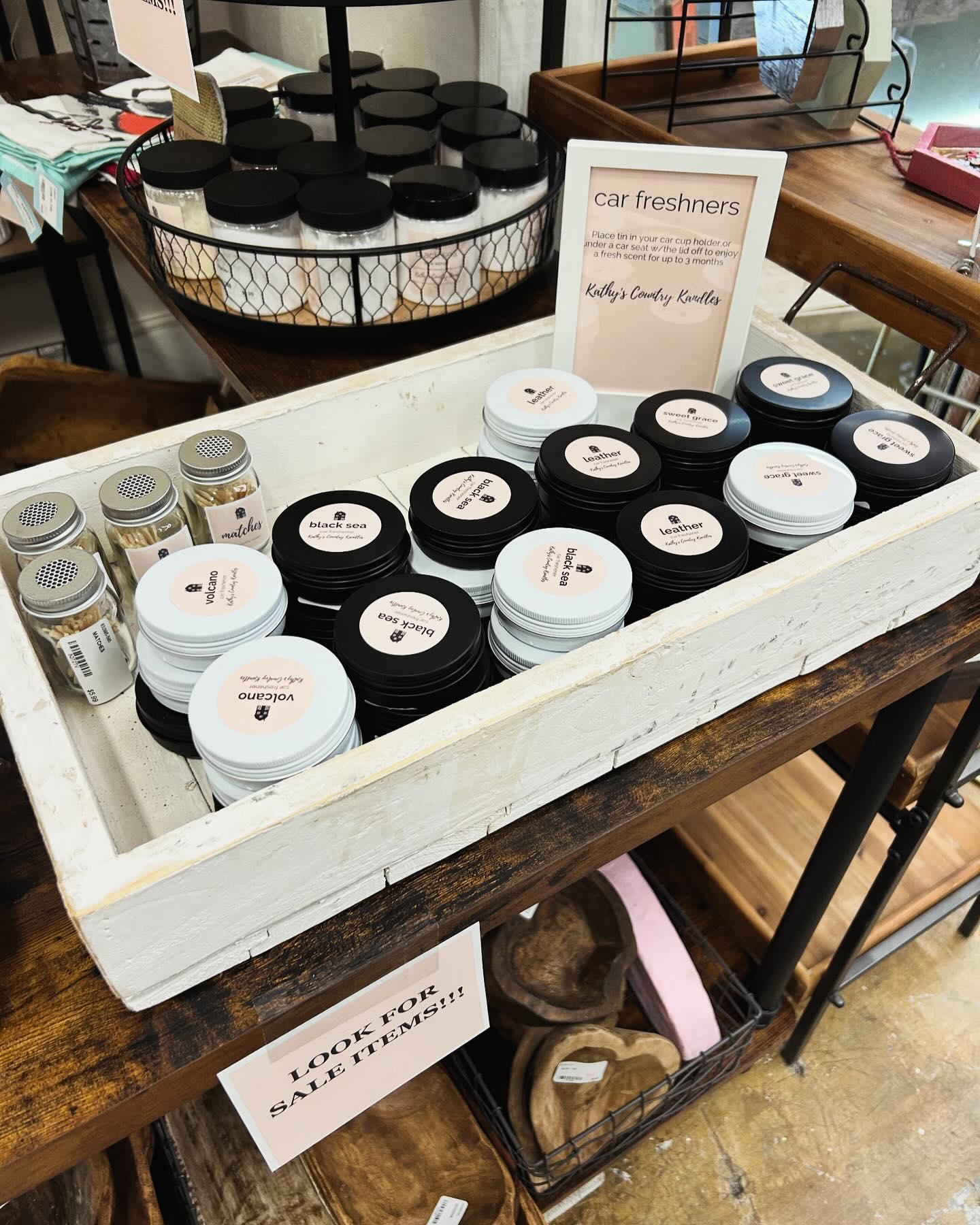 An assortment of handmade car fresheners in small jars in a boutique.