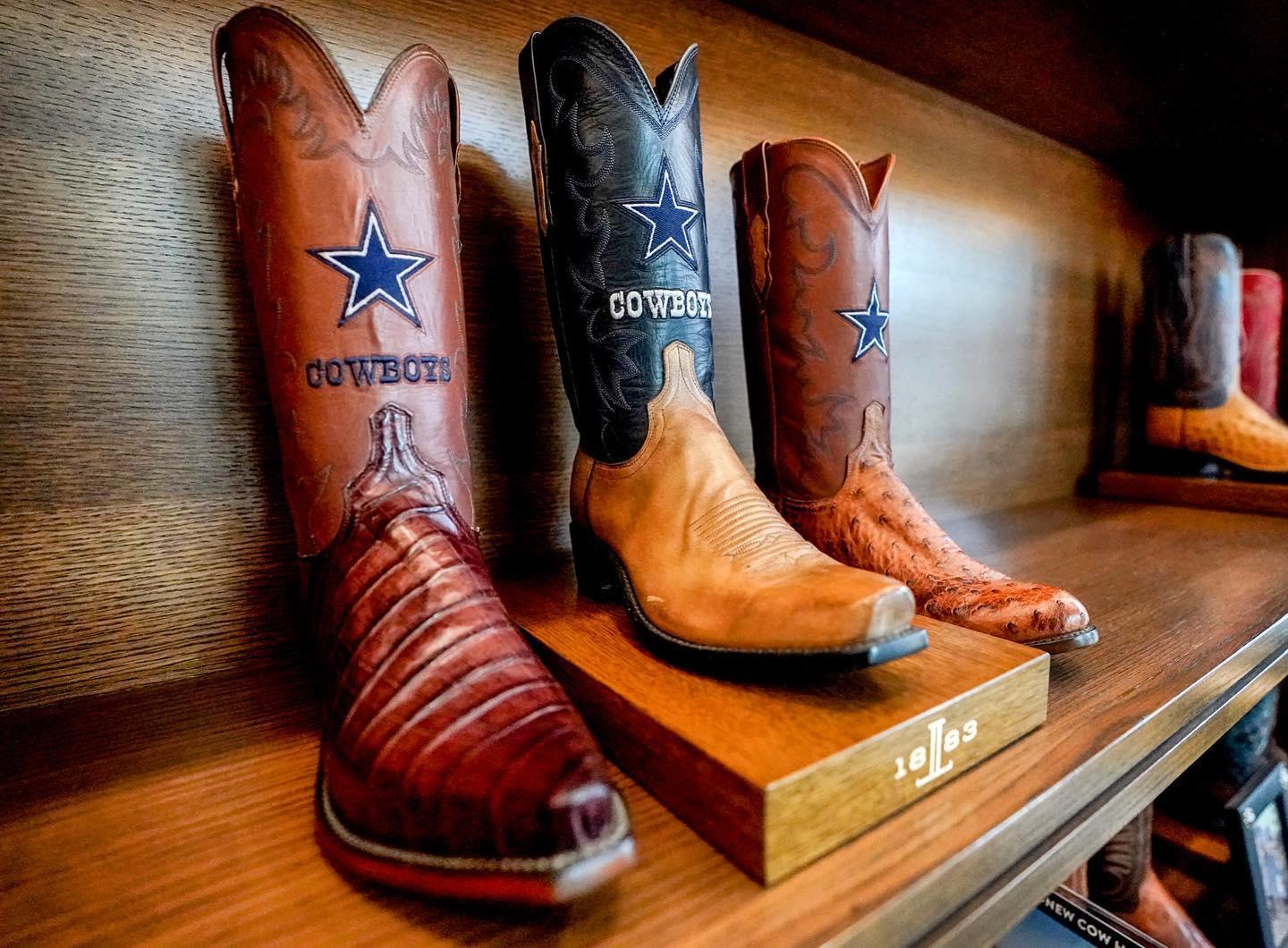 Three leather cowboy boots with star details on display in a boutique in Frisco.