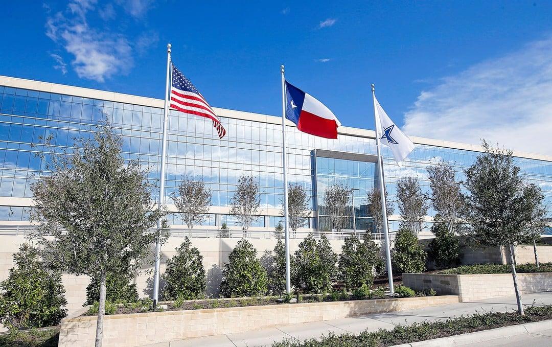 a glass building showing the sky's reflection