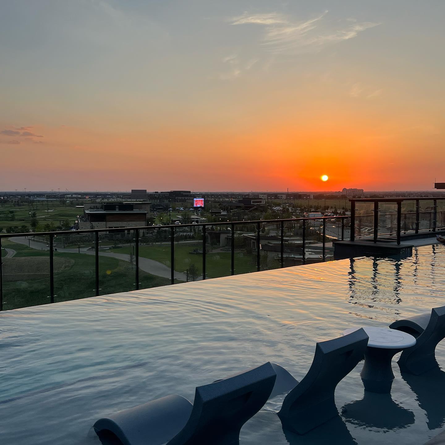 A pool on a balcony at sunset
