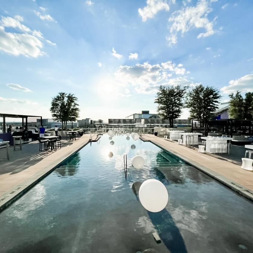 A pool with white balloons floating on top