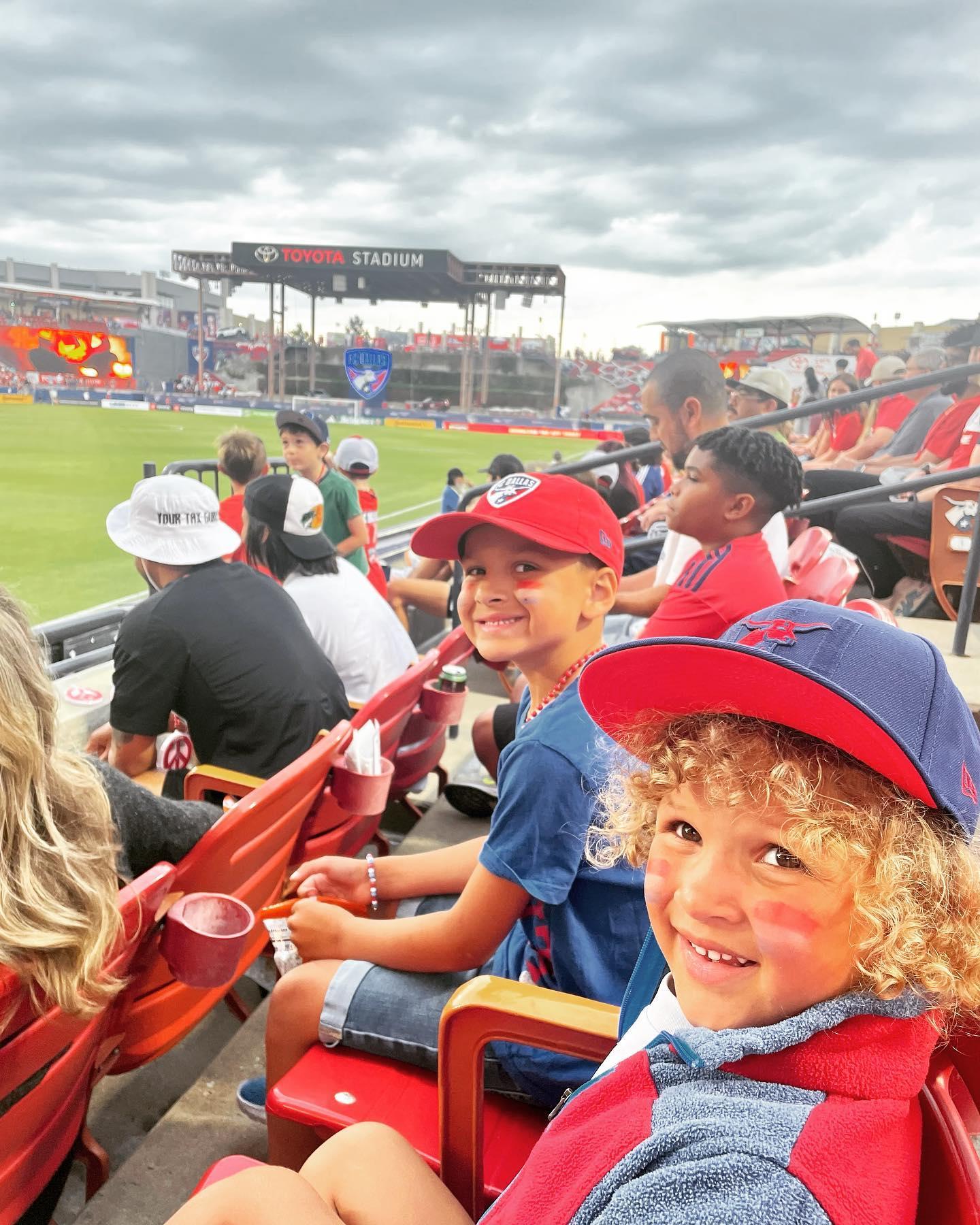 little boys watching a baseball game