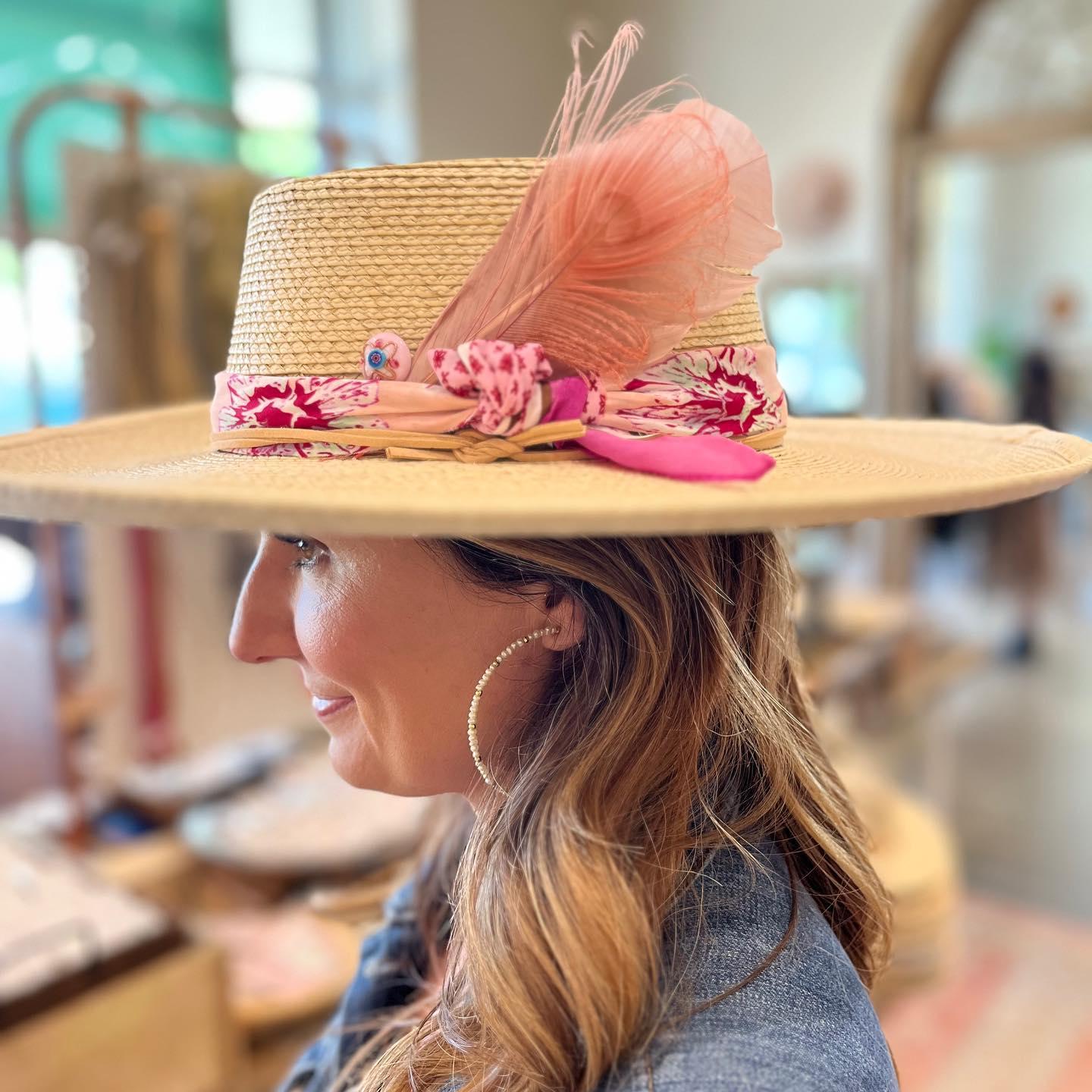a woman trying on a hat