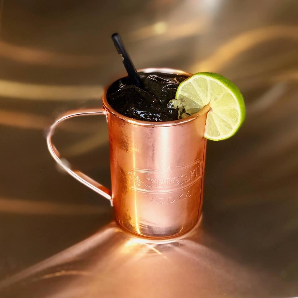 a copper colored cocktail mug with lime garnished on the rim