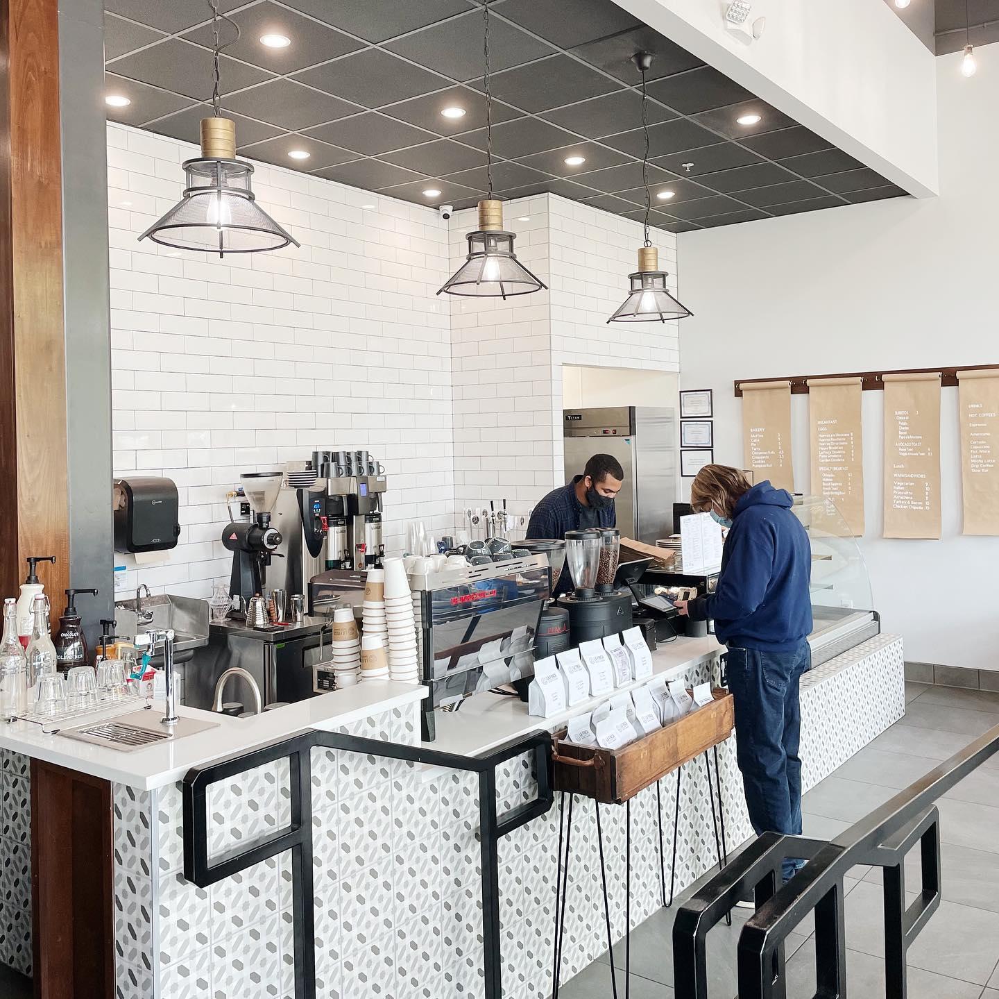 a man buying coffee at a cafe