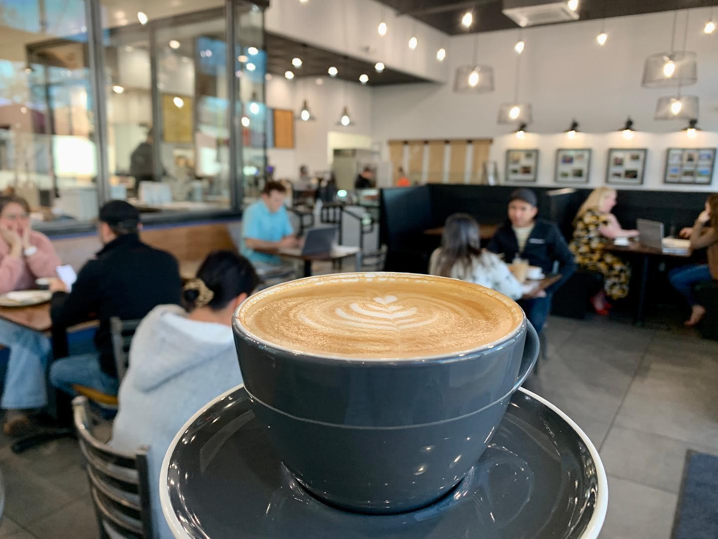a person holding a latte