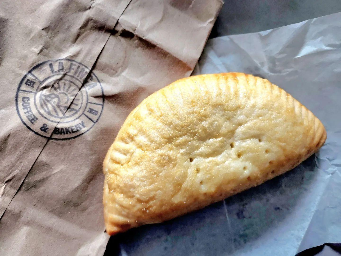a stuffed pastry resting on parchment paper