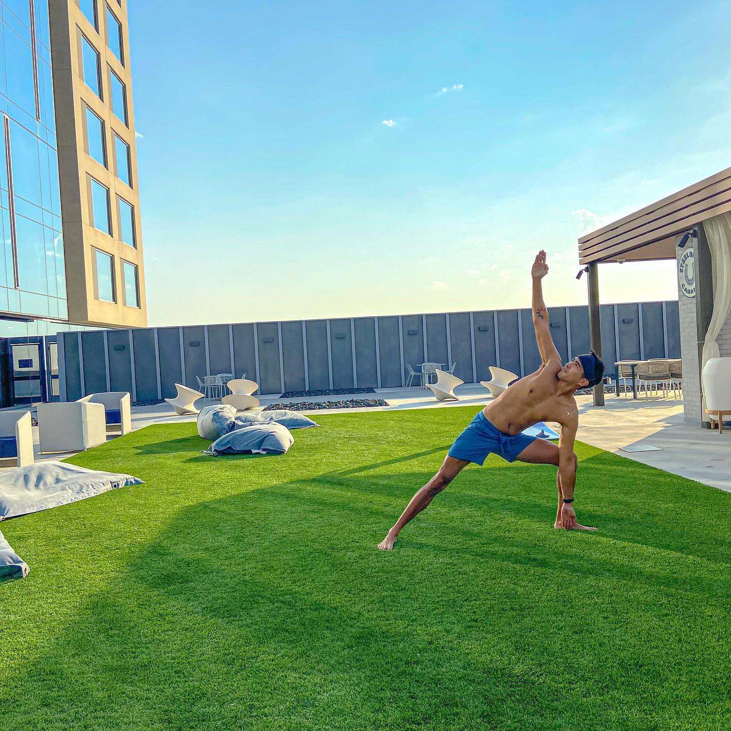 a man doing yoga on the grass