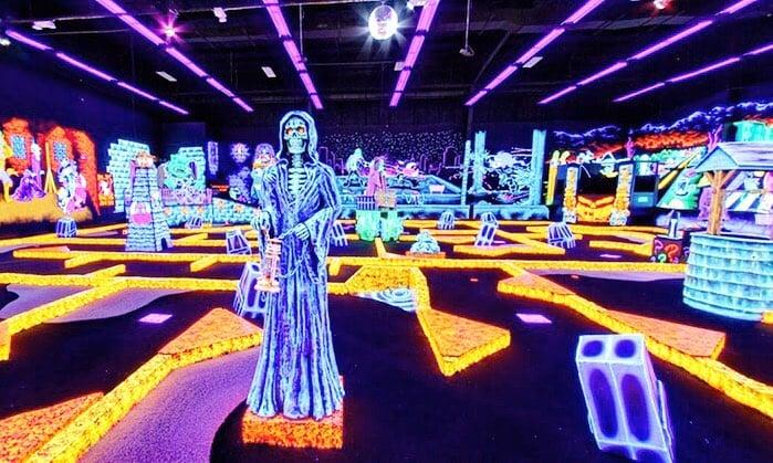 glow in the dark mini golf course with various sculptures