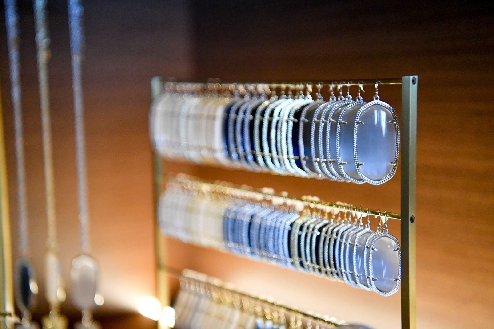 Various handcrafted pendants hanging on a display rack
