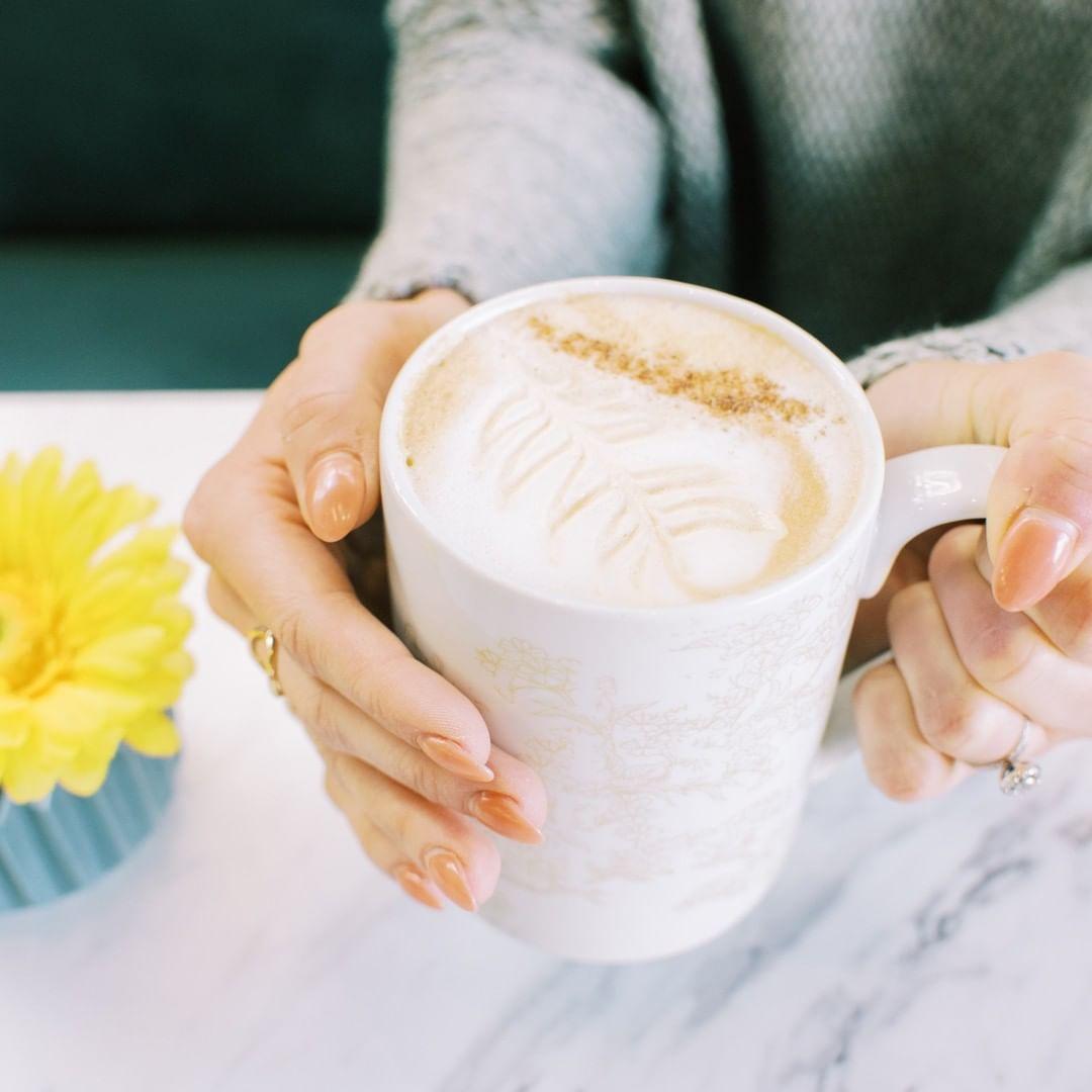 a woman holding a mug of coffee