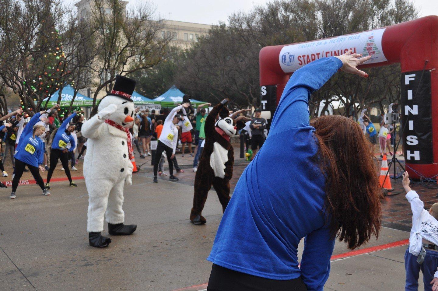 runners stretching with Frosty and Rudolph