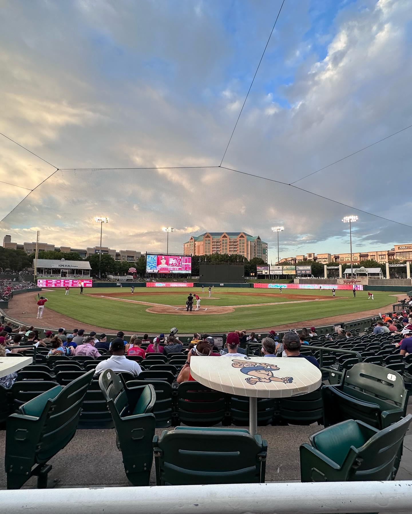 A view from the baseball diamond stand of the field while the game is on