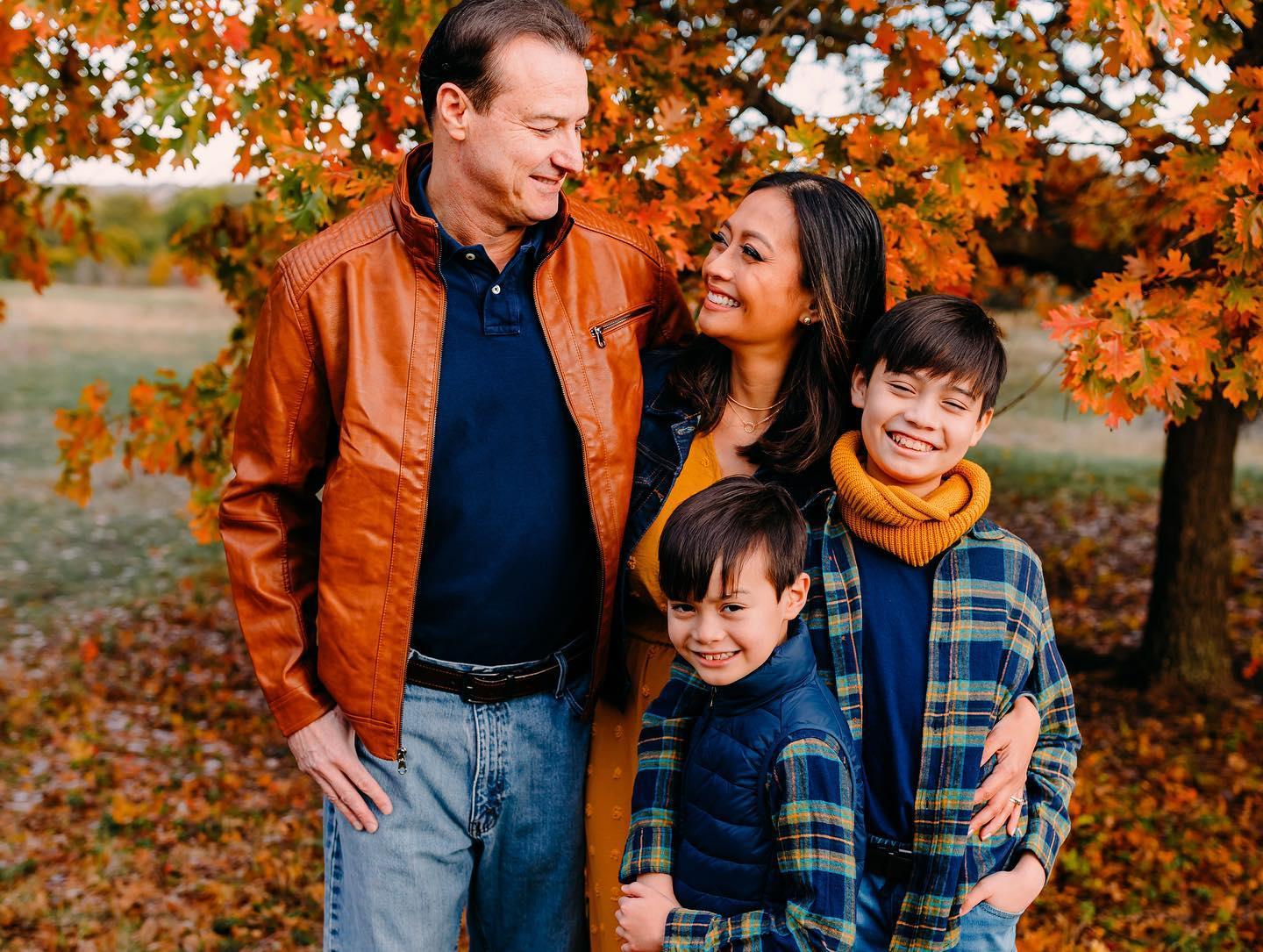 A Family posing for fall family  photos