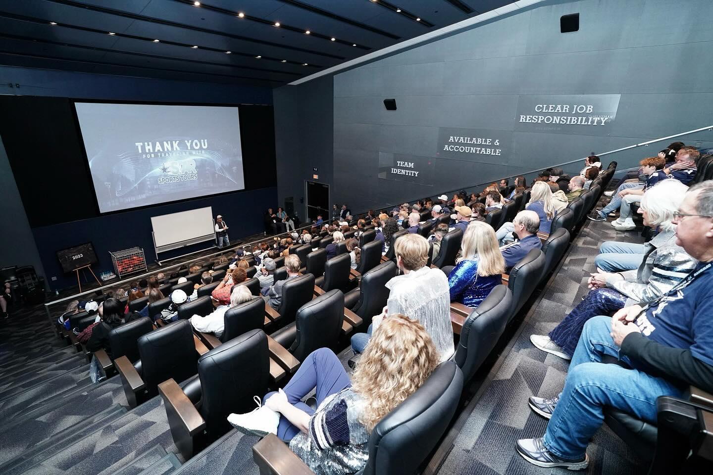 A bunch of people attending a conference in a auditorium