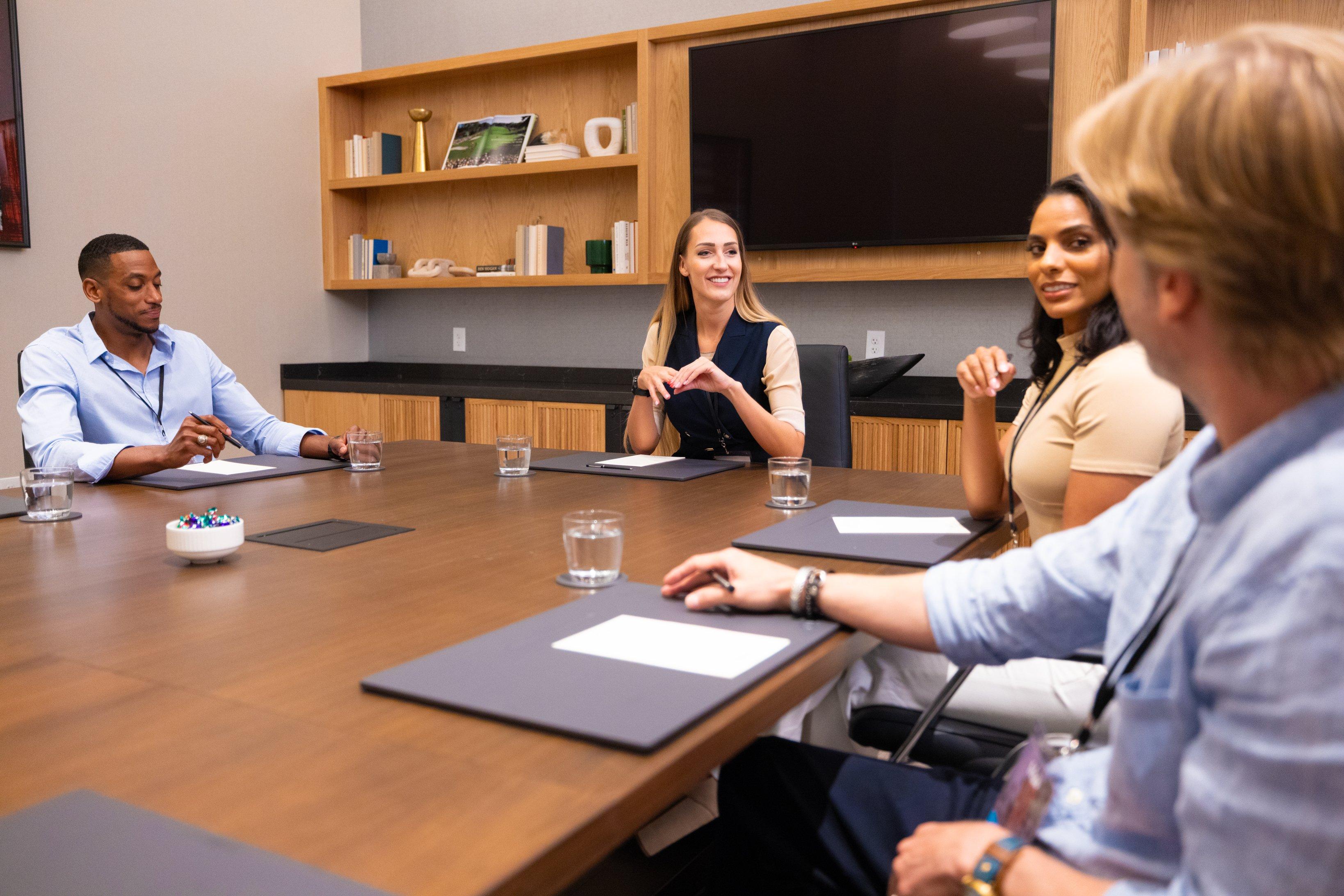 Four people in a meeting in a meeting room