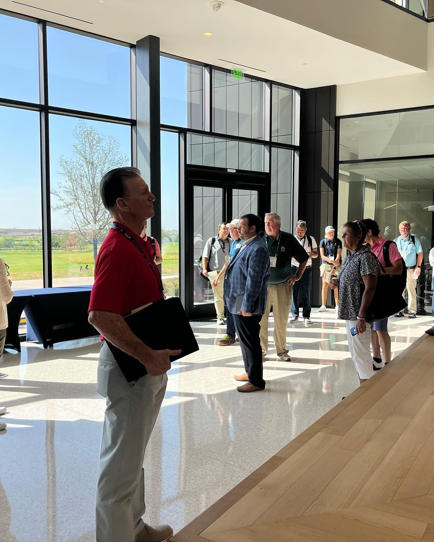 Many people standing in a room looking around