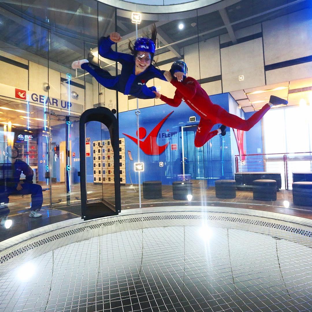 A girl being trained how to use a no gravity machine