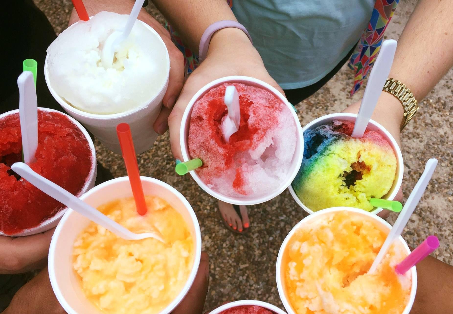 A assortment of slushies being held by several people