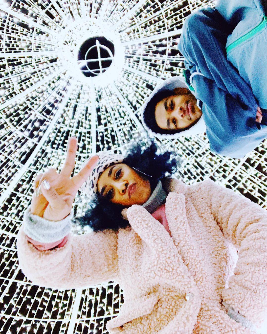 a couple posing in a light sculpture