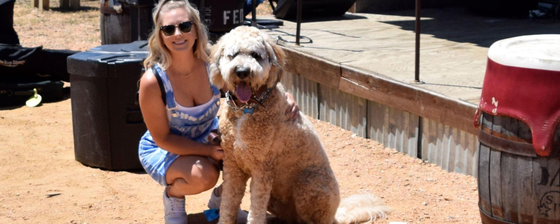 A woman and a dog posing