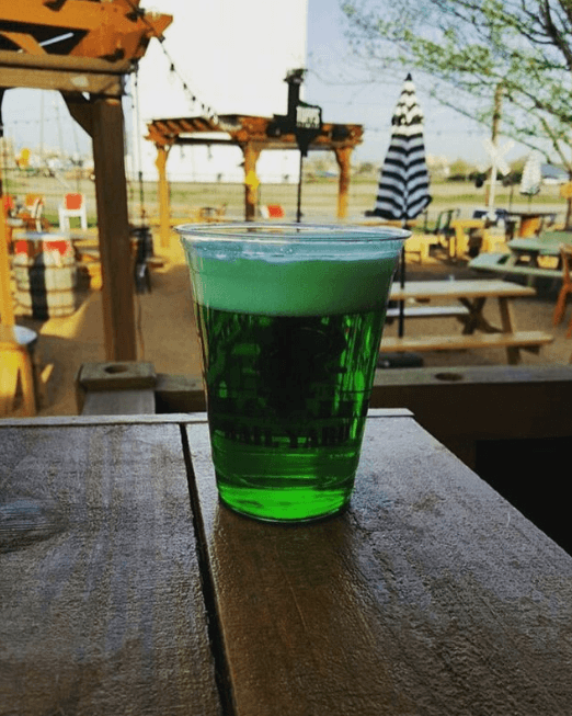 A green beer on a patio table at Frisco Rail Yard for St. Patrick's Day.